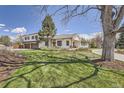 Beautiful home featuring well-manicured lawn, attractive landscaping, and an inviting front porch perfect for relaxation at 6102 S Aberdeen St, Littleton, CO 80120
