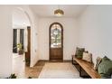 Welcoming foyer with hardwood floors, arched doorway, and stylish wooden front door at 6102 S Aberdeen St, Littleton, CO 80120