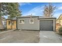 Well-maintained single-Gathering home with gray siding, an attached garage, and mature trees at 1765 Kingston St, Aurora, CO 80010