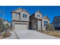 Two-story home with a three-car garage and classic gray and brown color scheme at 1715 Pioneer Cir, Lafayette, CO 80026