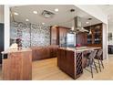 Modern kitchen with stainless steel appliances, custom backsplash, hardwood floors and granite countertops at 2000 Little Raven St # 501, Denver, CO 80202
