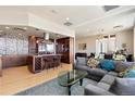 Open-concept living room and kitchen with modern decor, hardwood floors, and stainless steel appliances at 2000 Little Raven St # 501, Denver, CO 80202