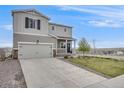 Lovely two-story home with a welcoming porch, attached garage, and a well-kept front yard and landscaping at 4811 River Highlands Loop, Elizabeth, CO 80107