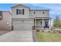 Beautiful two-story home with a charming front porch, well-maintained lawn, and a convenient two-car garage at 4811 River Highlands Loop, Elizabeth, CO 80107