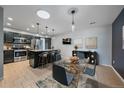 Modern eat-in kitchen featuring stainless appliances, a skylight, granite countertops and black cabinetry at 2761 S Xanadu Way, Aurora, CO 80014
