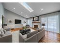 Bright living room featuring hardwood floors, fireplace, and a skylight for lots of natural light at 2761 S Xanadu Way, Aurora, CO 80014