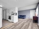 The open-concept living room connects to the kitchen and features light wood flooring at 3355 S Flower St # 131, Lakewood, CO 80227