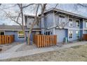 Charming two-story townhouse with a small fenced yard and mature tree, providing privacy and curb appeal at 8487 Everett Way # E, Arvada, CO 80005