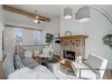 Cozy living room featuring a fireplace, wooden beams, and comfortable seating with soft textures and elegant décor at 8487 Everett Way # E, Arvada, CO 80005