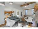 Open concept living area flowing into the kitchen, with hardwood floors, a fireplace, and stylish contemporary furniture at 8487 Everett Way # E, Arvada, CO 80005