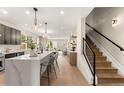 Open-concept kitchen with quartz island, modern fixtures, and a seamless transition to the living spaces at 4570 N Raleigh St, Denver, CO 80212