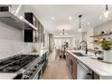 Gourmet kitchen with stainless steel appliances, custom cabinetry, and stylish modern lighting at 4570 N Raleigh St, Denver, CO 80212