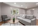 Bright living room featuring hardwood floors, recessed lighting, and a cozy bay window at 5174 Dudley St, Arvada, CO 80002