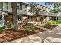 Two-story townhome with brick and siding exterior, landscaping, and a walkway at 7114 E Briarwood Dr, Centennial, CO 80112