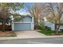 Charming single-Gathering home showcasing a well-kept lawn, driveway, and attached two-car garage at 17613 E Ohio Cir, Aurora, CO 80017