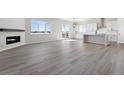 Open living room with laminate floors and a modern fireplace at 4704 Twelve Oaks Way, Castle Rock, CO 80104