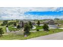 Expansive home featuring a well-maintained lawn, bordered by lush trees and rock features at 555 Heritage Trl, Elizabeth, CO 80107