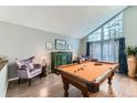 Bright game room with pool table, hardwood floors, and large windows with natural light at 10360 Irving Ct, Westminster, CO 80031
