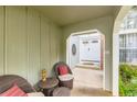 Inviting covered porch with seating area leads to the main entrance of the home at 10360 Irving Ct, Westminster, CO 80031
