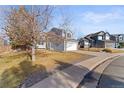 Two-story house with gray siding, attached garage, and basketball hoop at 5418 S Fundy Cir, Centennial, CO 80015