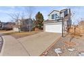 Two-story house with gray siding, attached garage, and basketball hoop at 5418 S Fundy Cir, Centennial, CO 80015