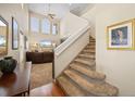 Bright foyer with high ceilings, elegant staircase, and an open view into the living area, perfect for greeting guests at 5591 Canyon View Dr, Castle Rock, CO 80104