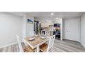 Dining area features wood table and chairs, alongside stainless steel appliances in the kitchen at 8826 E Florida Ave # G12, Denver, CO 80247