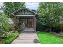 Charming brick home featuring a landscaped front yard and inviting porch at 3019 Meade St, Denver, CO 80211