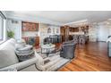 A gorgeous living room features hardwood floors, a stone accent wall, bar area and an open layout at 1551 Larimer St # 2602, Denver, CO 80202