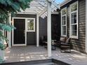 Covered porch with outdoor seating and a black front door at 3339 Lowell Blvd, Denver, CO 80211