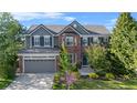 Beautiful two-story home boasts brick and siding facade, mature trees, and landscaped front yard at 17925 E Maplewood Dr, Aurora, CO 80016