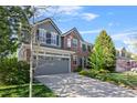Attractive two-story home featuring brick and siding, a spacious driveway, and well-manicured landscaping at 17925 E Maplewood Dr, Aurora, CO 80016