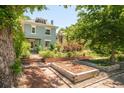 Charming two-story home with a well-maintained front yard and garden at 2228 N Race St, Denver, CO 80205