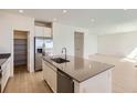 Modern kitchen with gray countertops, stainless steel appliances, and center island at 710 N Deer Park, Watkins, CO 80137