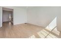 Open-concept living space with hardwood floors, bright white walls, and natural light at 710 N Deer Park, Watkins, CO 80137