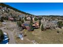 Beautiful aerial view of a mountain neighborhood with homes nestled in the trees at 783 Calgary Way, Golden, CO 80401