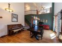 Elegant dining room featuring wood floors, high ceilings, a piano and a grand staircase at 783 Calgary Way, Golden, CO 80401