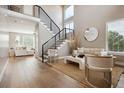 Bright living room with hardwood floors, modern furniture, and high ceilings at 147 Chapel Hill Cir, Brighton, CO 80601