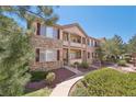 Charming two-story home with a stone facade, red shutters, and well-maintained landscaping at 7160 S Wenatchee Way # F, Aurora, CO 80016