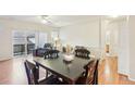 Inviting living area with hardwood floors, a sliding glass door, and ample seating at 7160 S Wenatchee Way # F, Aurora, CO 80016