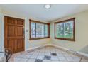 Welcoming foyer with tile flooring, a solid wood front door, and natural light streaming through the windows at 6260 W 45Th Pl, Wheat Ridge, CO 80033
