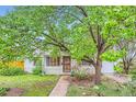 Inviting home showcasing a mature tree, tidy lawn, and a paved walkway leading up to the welcoming entrance at 6260 W 45Th Pl, Wheat Ridge, CO 80033