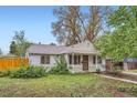 Well-kept home featuring a neat lawn, mature trees, and tidy landscaping, enhancing its curb appeal at 6260 W 45Th Pl, Wheat Ridge, CO 80033