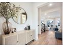 Bright foyer featuring hardwood floors, modern decor, and open access to the living room and stairway at 875 Coal Bank Trl, Castle Rock, CO 80104
