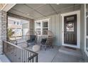 Charming front porch with stylish egg chairs and a welcoming wreath on the front door at 9380 Bear River St, Littleton, CO 80125