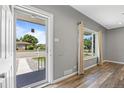 Inviting foyer features wood-look flooring, a window for natural light, and neutral paint at 2582 S Uno Way, Denver, CO 80219