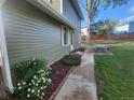 Side yard featuring walkway, flower beds, picnic table and lush green lawn at 6207 W 92Nd Pl, Westminster, CO 80031