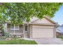 Inviting home with a covered porch and stone accents, offering a blend of comfort and style at 12021 Dahlia Dr, Thornton, CO 80241