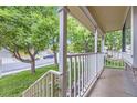 Cozy front porch view with white railings, perfect for relaxing and enjoying the neighborhood at 12021 Dahlia Dr, Thornton, CO 80241