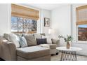 Cozy living room with a comfortable sectional, throw pillows, and natural light at 1535 Spruce St, Denver, CO 80220